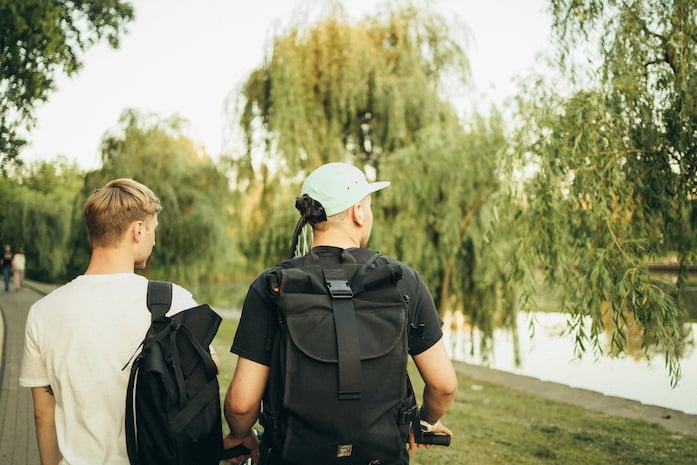 Two students walking in a park