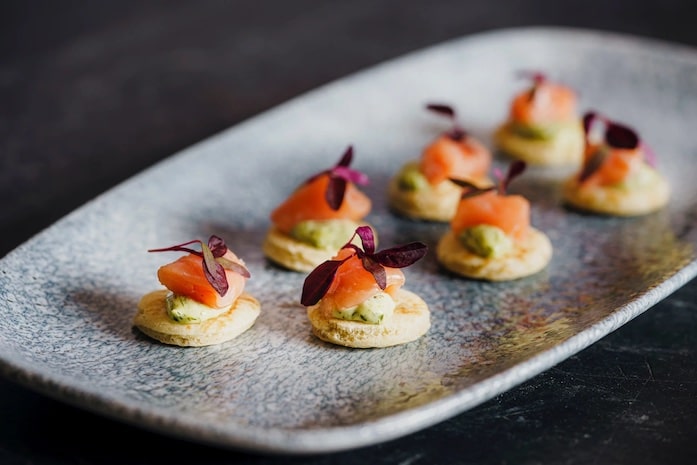 A plate of smoked salmon blinis