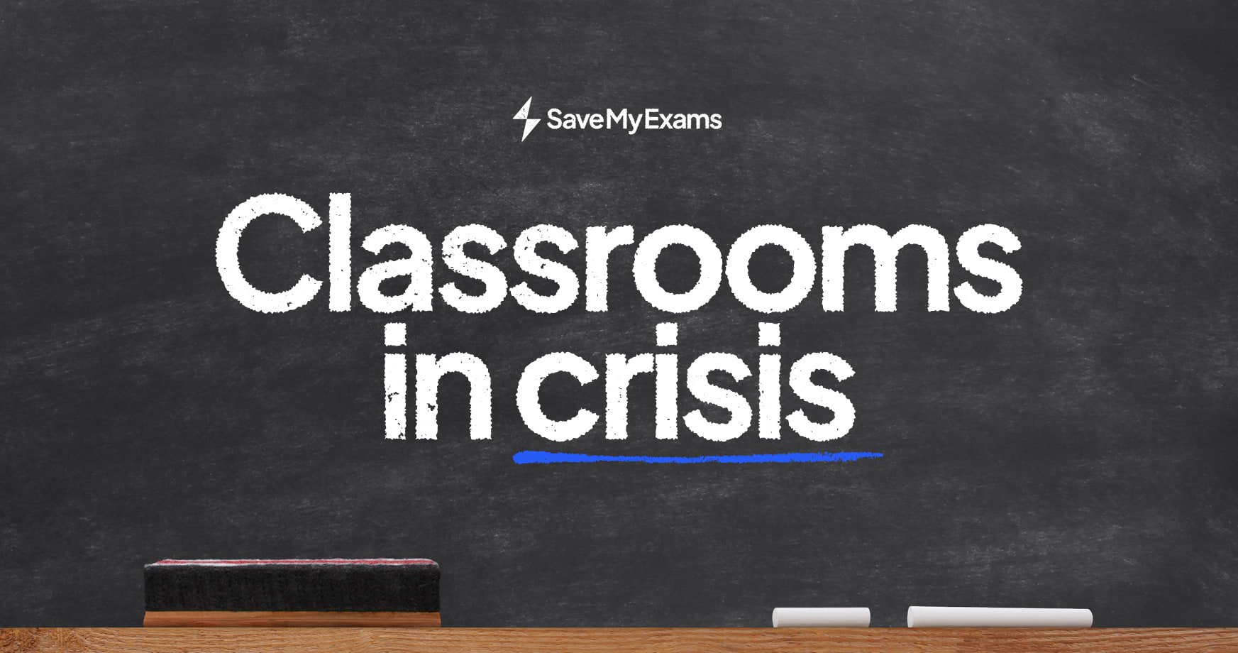 Chalkboard with "Classrooms in crisis" in white text, blue underline, two chalk pieces, and a duster on a wooden ledge; SaveMyExams logo above.